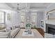 Cozy living room featuring a stone fireplace, coffered ceiling and abundant natural light from the large windows at 2906 Hillside Springs Dr, Charlotte, NC 28209