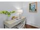 Bright office space with a light beige desk, chair and dark wood flooring with white walls and a framed art piece at 2906 Hillside Springs Dr, Charlotte, NC 28209
