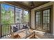 Relaxing screened porch with outdoor furniture, providing a serene space for leisure and entertainment at 2906 Hillside Springs Dr, Charlotte, NC 28209