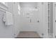 Modern walk-in shower featuring sleek white tile, glass door, and contemporary fixtures at 2906 Hillside Springs Dr, Charlotte, NC 28209