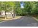 Street view featuring mature trees and a basketball hoop down the street from the property at 2906 Hillside Springs Dr, Charlotte, NC 28209