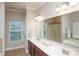 Bathroom featuring double vanity, large mirror, soaking tub, and separate shower at 3664 Privette Rd, Matthews, NC 28104