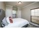 Bedroom with neutral walls, plush carpet, and two windows providing natural light at 3664 Privette Rd, Matthews, NC 28104