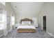 Spacious bedroom with vaulted ceilings, neutral paint, and light-colored carpet and wood furnishings at 3664 Privette Rd, Matthews, NC 28104