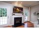 Living room fireplace with hardwood floors, creating a cozy and inviting atmosphere for relaxation and entertainment at 3664 Privette Rd, Matthews, NC 28104