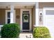 Welcoming front entrance with a wreath on the door and well-manicured landscaping, creating great curb appeal at 3664 Privette Rd, Matthews, NC 28104