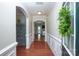 Elegant hallway with hardwood floors, decorative molding, and arched doorways leading to other living spaces at 3664 Privette Rd, Matthews, NC 28104