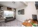 Comfortable office featuring a gray sofa, built-in shelves, and a wooden desk workspace at 3664 Privette Rd, Matthews, NC 28104