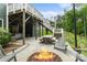 Backyard featuring a stone patio, fire pit, hot tub under deck, and dining area, for outdoor entertainment at 3817 Arial Ln # 145, York, SC 29745