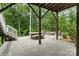 Stone patio featuring a built-in fire pit and a dining area, ideal for outdoor entertaining in a lush backyard at 3817 Arial Ln # 145, York, SC 29745