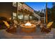 Backyard patio with a stone fire pit, Adirondack chairs, and string lights, offering an inviting outdoor retreat at 3817 Arial Ln # 145, York, SC 29745