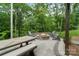 Stone fire pit surrounded by Adirondack chairs and a picnic table, perfect for enjoying the outdoors at 3817 Arial Ln # 145, York, SC 29745