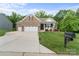 Beautiful brick home features a two-car garage, well-manicured lawn, and welcoming front porch on a sunny day at 3817 Arial Ln # 145, York, SC 29745