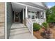 Inviting front porch features white railings, comfortable seating, and a beautifully decorated front door at 3817 Arial Ln # 145, York, SC 29745