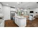 Open concept kitchen with a center island and views into the living area with fireplace at 3817 Arial Ln # 145, York, SC 29745