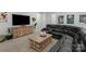 Spacious living room with a sleek black couch, wooden furniture, and a large screen TV at 3817 Arial Ln # 145, York, SC 29745