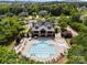 An aerial view of a community clubhouse featuring a luxurious swimming pool surrounded by lounge chairs and lush landscaping at 3817 Arial Ln # 145, York, SC 29745