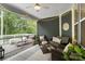 Screened-in porch with cozy seating, area rug, string lights and ceiling fan overlooking wooded area at 3817 Arial Ln # 145, York, SC 29745