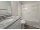 Modern bathroom featuring a granite vanity, shower, and tub combination at 406 4Th St, Spencer, NC 28159