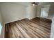 Spacious bedroom featuring new wood flooring, neutral walls, and ceiling fan at 406 4Th St, Spencer, NC 28159