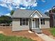 Inviting home featuring neutral siding and black shutters surrounded by a manicured lawn at 406 4Th St, Spencer, NC 28159