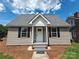 Charming home featuring a gray roof, neutral siding, and dark shutters at 406 4Th St, Spencer, NC 28159