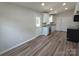 Open-concept kitchen featuring modern appliances, granite countertops, and hardwood floors at 406 4Th St, Spencer, NC 28159