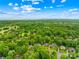 An aerial view showcases the serene neighborhood with tree-lined streets and beautiful homes nestled among mature trees and landscaping at 4339 Shannamara Dr, Matthews, NC 28104