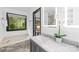 Bright bathroom with marble countertops, tub under window, and modern lighting fixtures at 4339 Shannamara Dr, Matthews, NC 28104