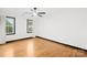 Bright, spacious bedroom with hardwood floors, black window trim and a ceiling fan at 4339 Shannamara Dr, Matthews, NC 28104
