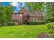 Beautiful two-story brick home with a well-manicured lawn and a charming blue front door at 4339 Shannamara Dr, Matthews, NC 28104