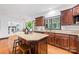 Kitchen island with bar stool seating, granite countertops, with stainless steel appliances at 4339 Shannamara Dr, Matthews, NC 28104