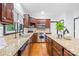 Well-lit kitchen features stainless steel appliances, granite countertops, and ample cabinet space at 4339 Shannamara Dr, Matthews, NC 28104
