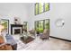 Bright living room with fireplace, high ceilings and large windows providing lots of natural light at 4339 Shannamara Dr, Matthews, NC 28104