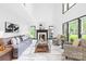 Bright living room with fireplace, high ceilings and large windows providing lots of natural light at 4339 Shannamara Dr, Matthews, NC 28104