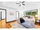 Bright main bedroom features a tray ceiling, a ceiling fan, and an ensuite bathroom at 4339 Shannamara Dr, Matthews, NC 28104