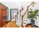 Inviting staircase with hardwood steps, white risers, and dark doorframes leading to other rooms at 4339 Shannamara Dr, Matthews, NC 28104