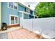 Private back patio area with brick pavers, white fence, and grill, perfect for relaxing outdoors at 461 Hurston Cir # 51, Charlotte, NC 28208