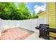 Outdoor brick patio with white privacy fence and grill at 461 Hurston Cir # 51, Charlotte, NC 28208