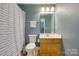 This bathroom has blue painted walls, a shower and vanity with white towels at 461 Hurston Cir # 51, Charlotte, NC 28208
