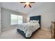 Bright bedroom with a blue upholstered bed frame, ceiling fan, and large windows at 461 Hurston Cir # 51, Charlotte, NC 28208