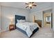 Cozy bedroom featuring a blue upholstered bed frame, ceiling fan, and carpet flooring at 461 Hurston Cir # 51, Charlotte, NC 28208