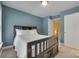 This blue bedroom features carpet flooring, white trim, and a ceiling light fixture at 461 Hurston Cir # 51, Charlotte, NC 28208