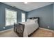 Blue bedroom featuring a dark wood bed frame, carpet floor and natural light at 461 Hurston Cir # 51, Charlotte, NC 28208