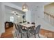 Stylish dining area with modern lighting and seating for six at 461 Hurston Cir # 51, Charlotte, NC 28208