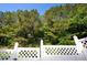 Lattice accented gate providing access to a wooded and landscaped backyard at 4938 Sunset Ridge Ct, Charlotte, NC 28269