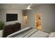 Bedroom featuring a ceiling fan, tv, view to en suite bathroom, and view to doorway at 4938 Sunset Ridge Ct, Charlotte, NC 28269
