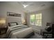Bedroom with a window providing natural light, neutral walls, carpet, and ceiling fan at 4938 Sunset Ridge Ct, Charlotte, NC 28269