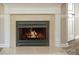 Close-up of a stylish fireplace with mantel, tile surround, and modern design elements at 4938 Sunset Ridge Ct, Charlotte, NC 28269