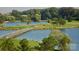 Scenic golf course view with a lake, bridge, and lush green landscape at 4938 Sunset Ridge Ct, Charlotte, NC 28269